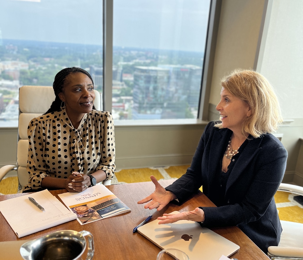 Lisa and a Client at a table going over materials